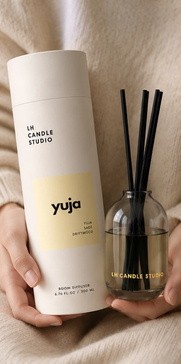 Hand holding the Yuja reed diffuser by LH Candle Studio