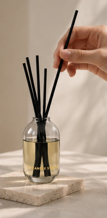 Inserting rattan reeds into an LH Candle Studio reed diffuser