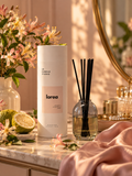 Lorea reed diffuser by LH Candle Studio on a vanity in warm golden-hour light